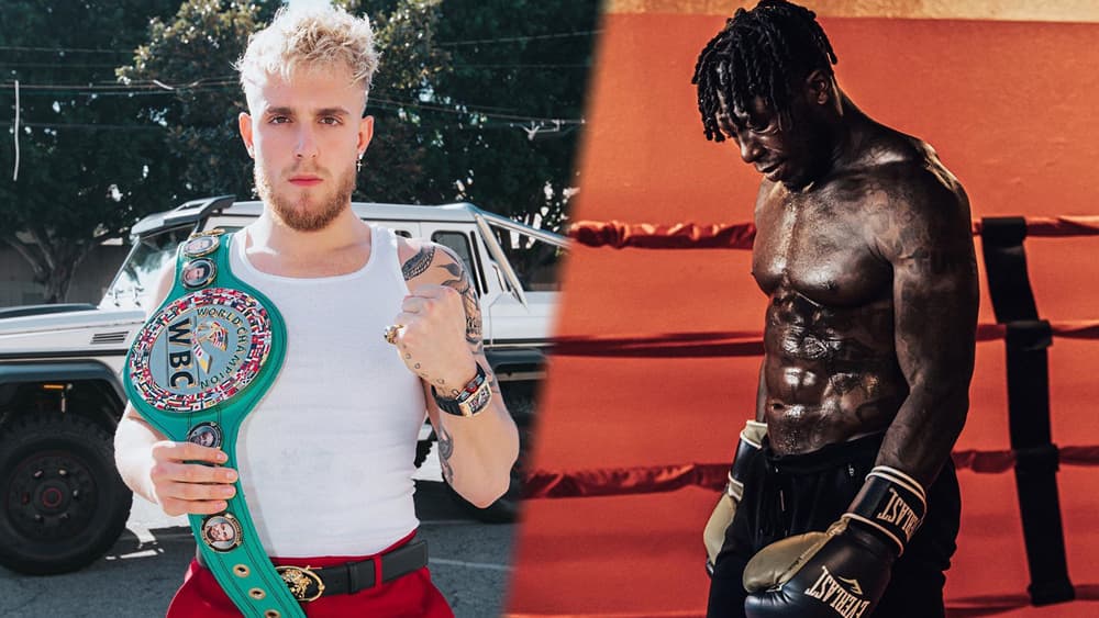 Jake Paul poses with a championship belt while Nate Robinson is poised in boxing attire.