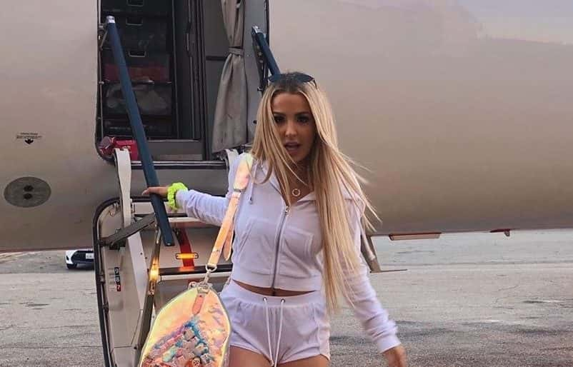 An image of tana mongeau exiting a plane.