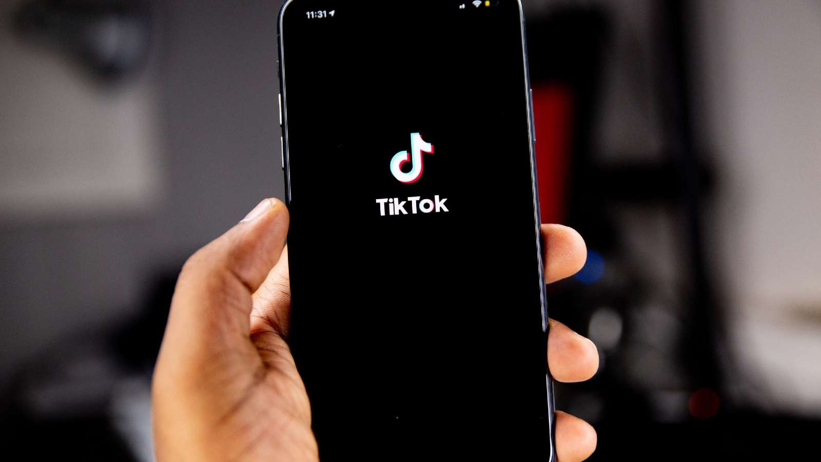 hand holding phone tiktok app