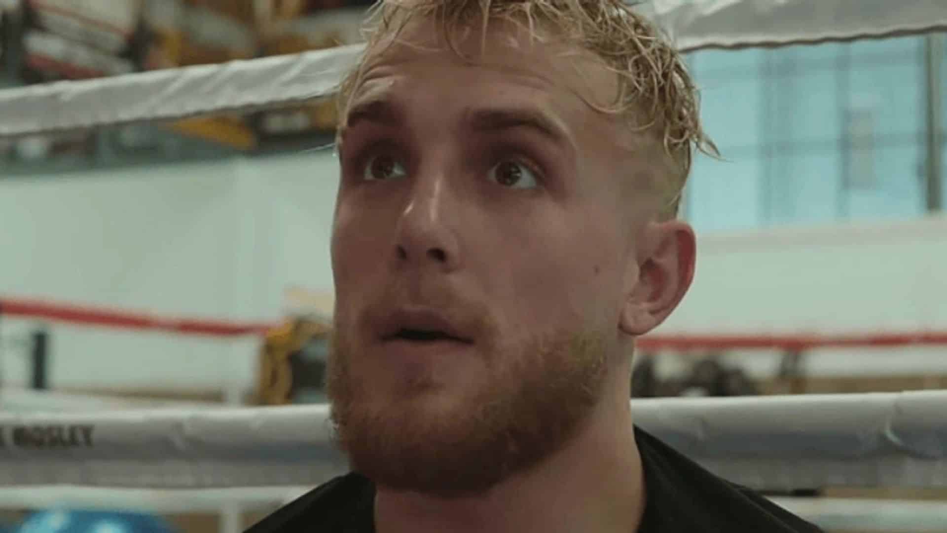 Jake Paul sitting next to boxing ring ropes