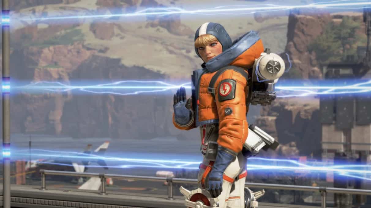 Apex Legends woman in orange jacket and blue hood waves at players in front of an electric fence