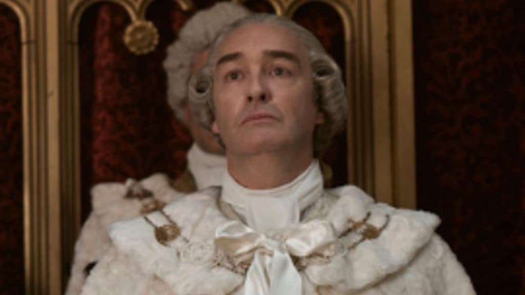 A close up of Earl Harcourt wears an official robe in Queen Charlotte: A Bridgerton Story