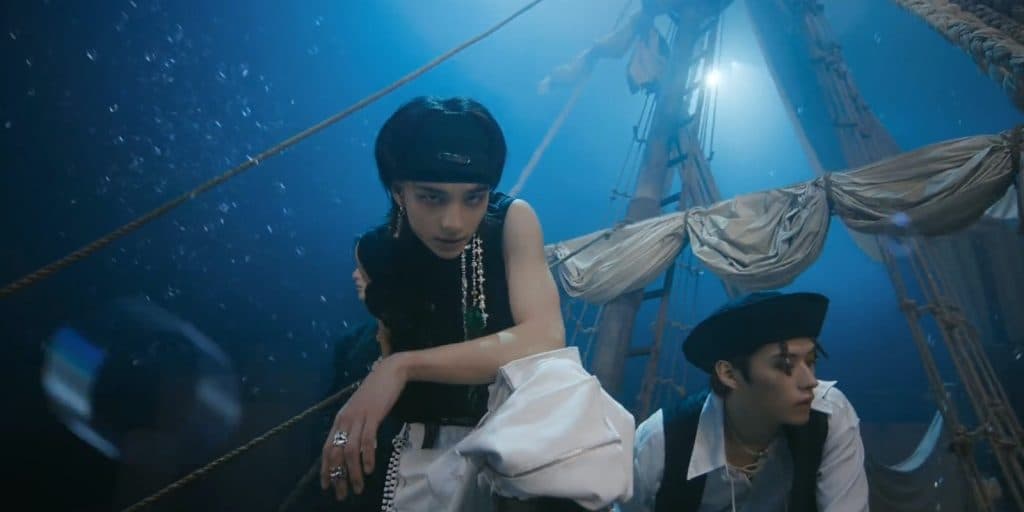 Stray Kids performing on a pirate ship in their new music video, "Lalalala."