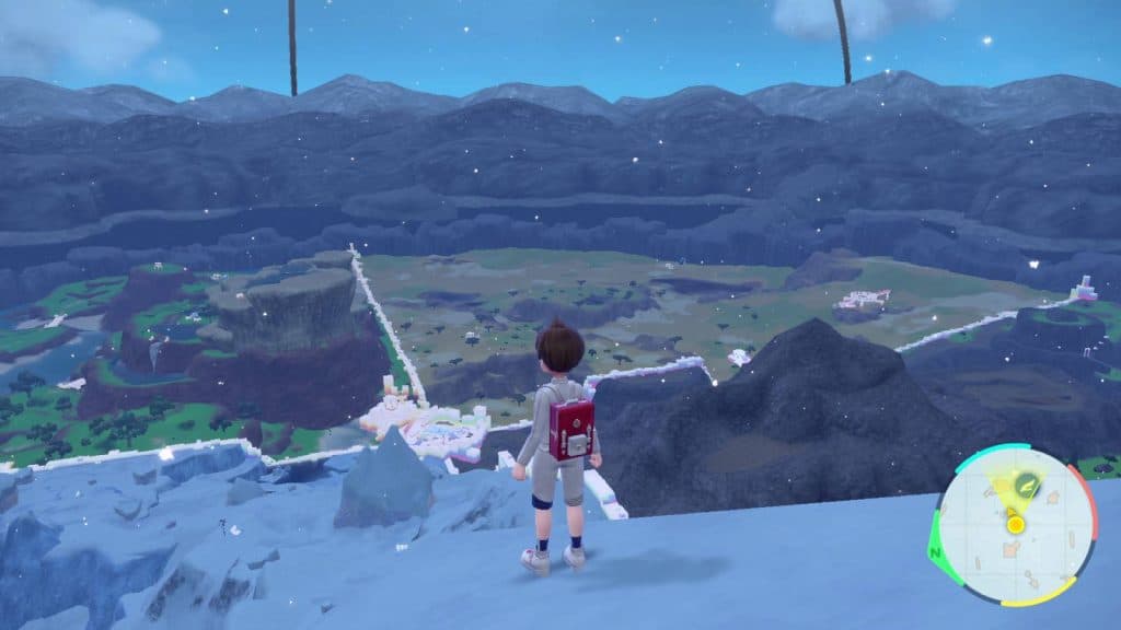 A Pokemon trainer stands on a hill, overlooking the four biomes from The Indigo Disk DLC