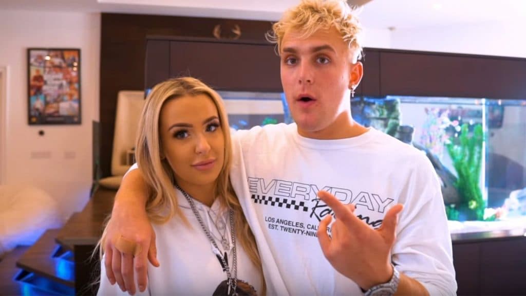 Jake Paul standing with his arm around wife Tana Mongeau.