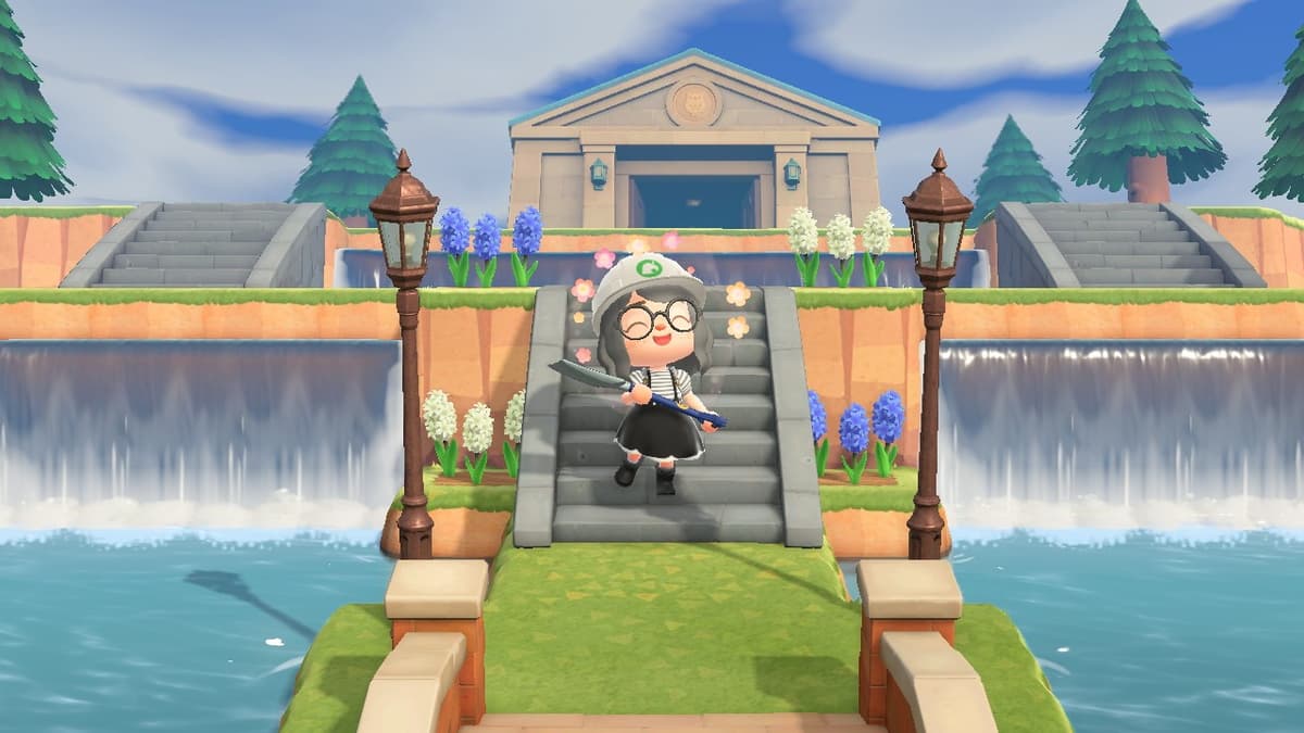 An image of a character standing at the bottom of some stairs overlooking a waterfall in Animal Crossing new horizons