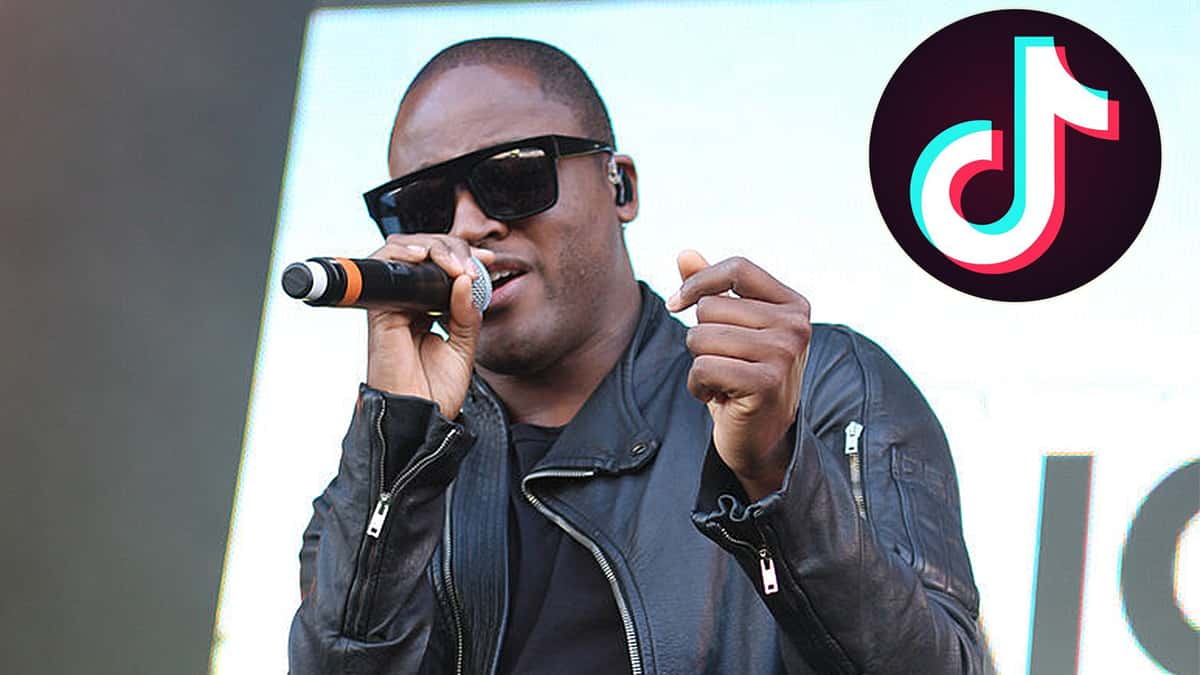 Taio Cruz on stage next to TikTok logo