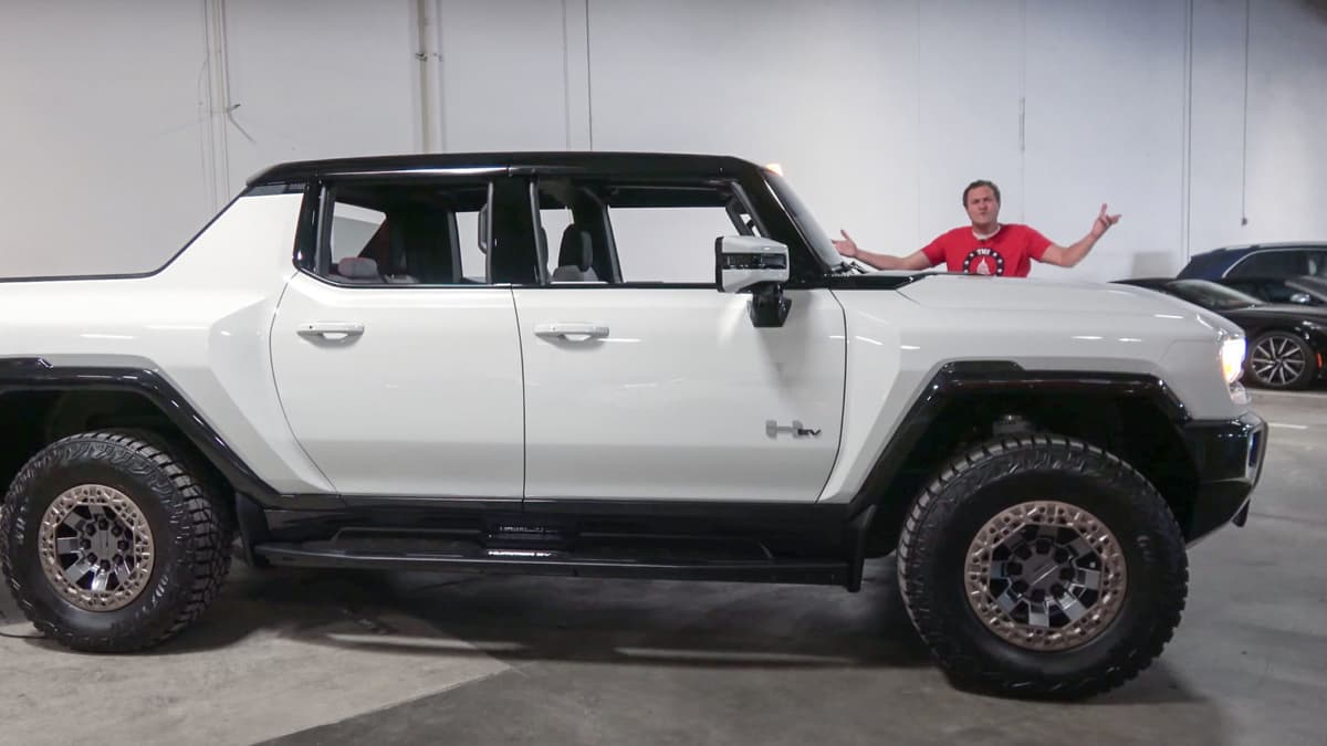 Doug DeMuro dwarfed by Hummer EV