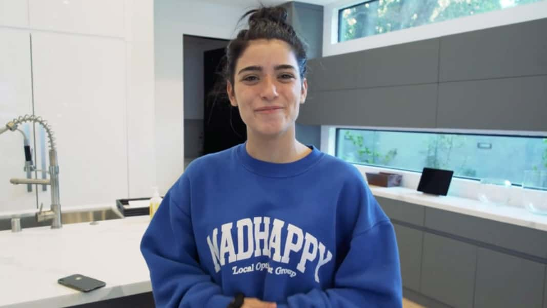 Dixie Damelio in her kitchen recording a YouTube video