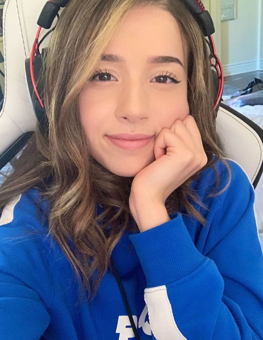 Pokimane poses for a selfie wearing headphones.