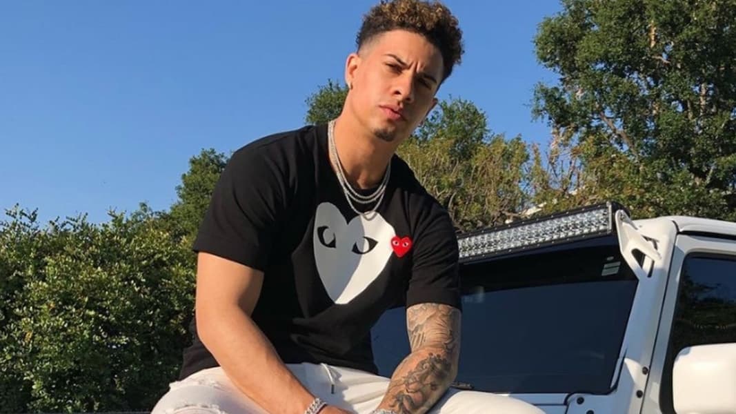 Austin McBroom sitting on car