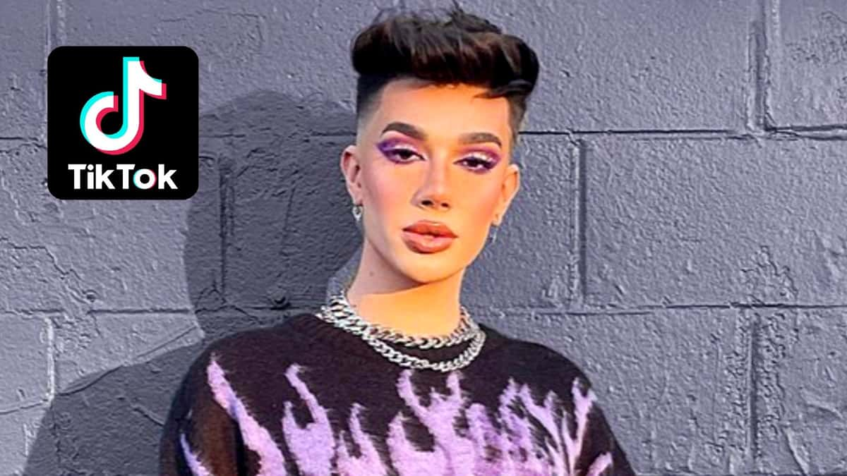 James Charles stands against a purple wall