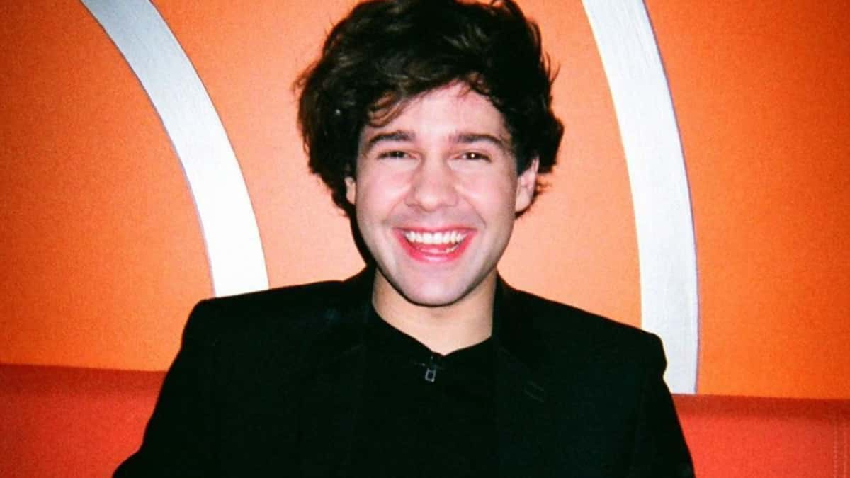 David Dobrik in front of an orange wall