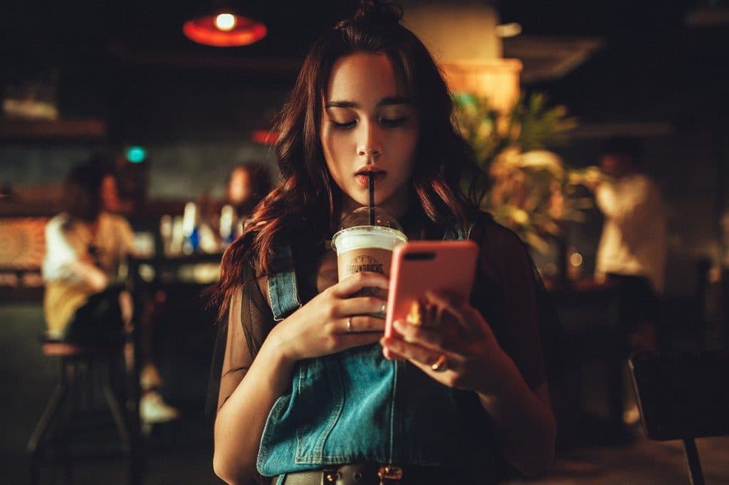 Girl on cellphone at starbucks