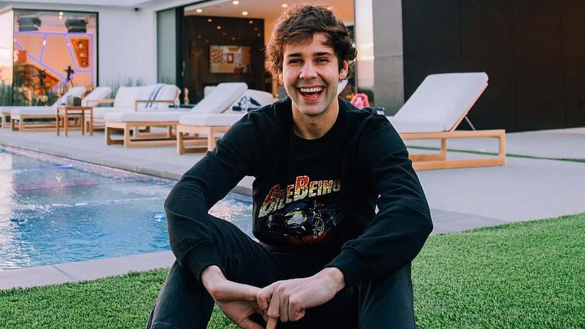 David Dobrik sitting by pool at LA mansion