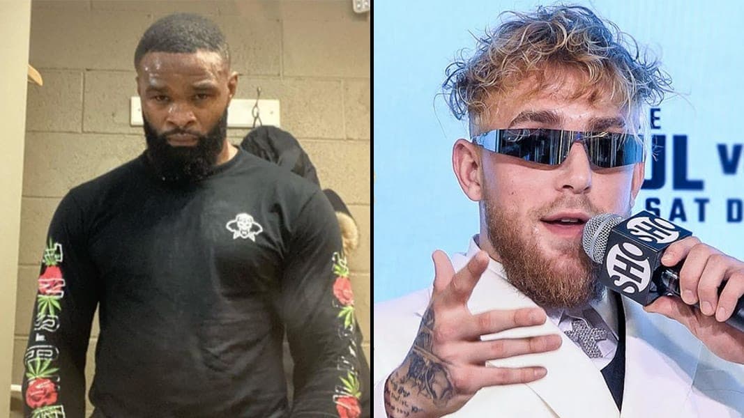 Tyron Woodley looking menacing at camera next to Jake Paul