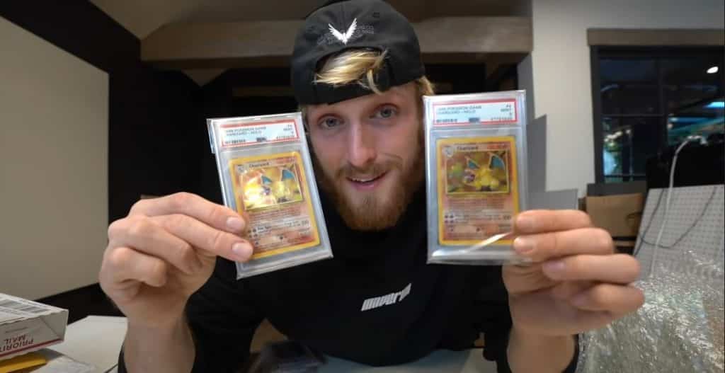 Logan Paul holding Charizard Pokemon cards screenshot.