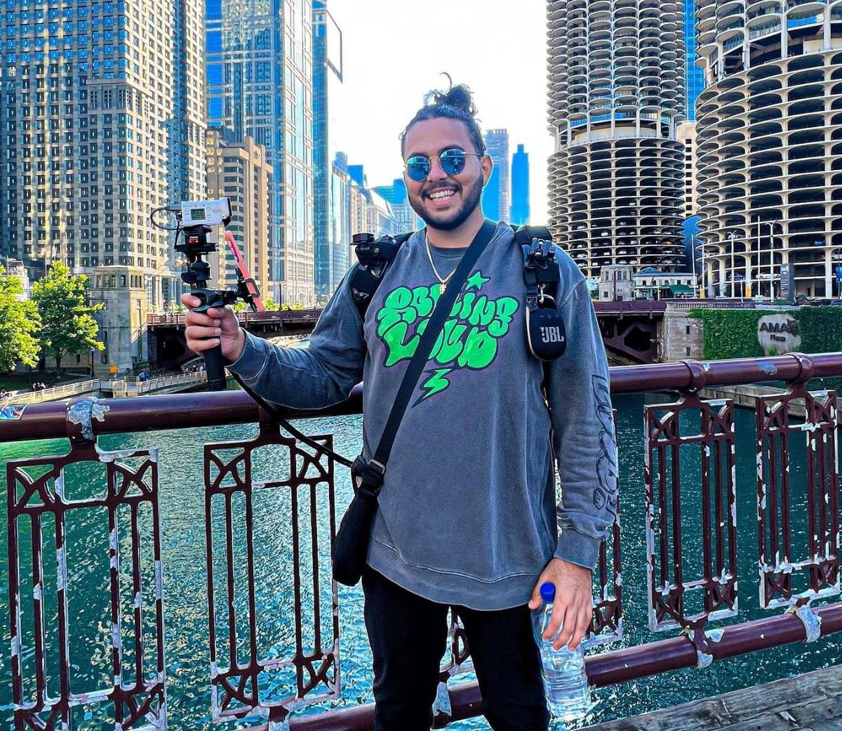 YourFellowArab on a bridge displaying his IRL streaming gear