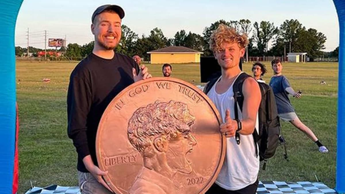 MrBeast and Ryan Trahan holding penny