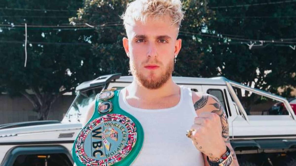 Jake Paul holding green boxing world title belt