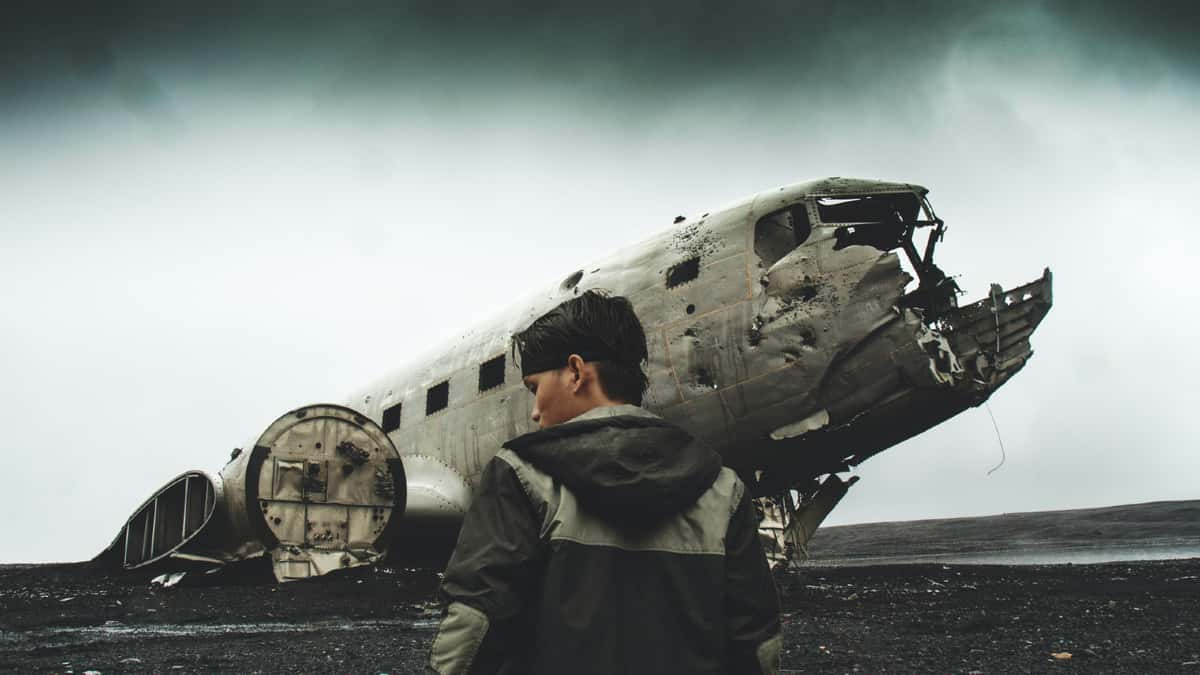 Man standing in front of crashed airplane