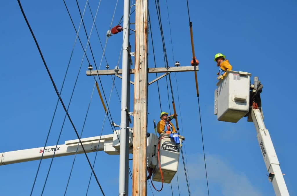 linemen working in a bucket truck