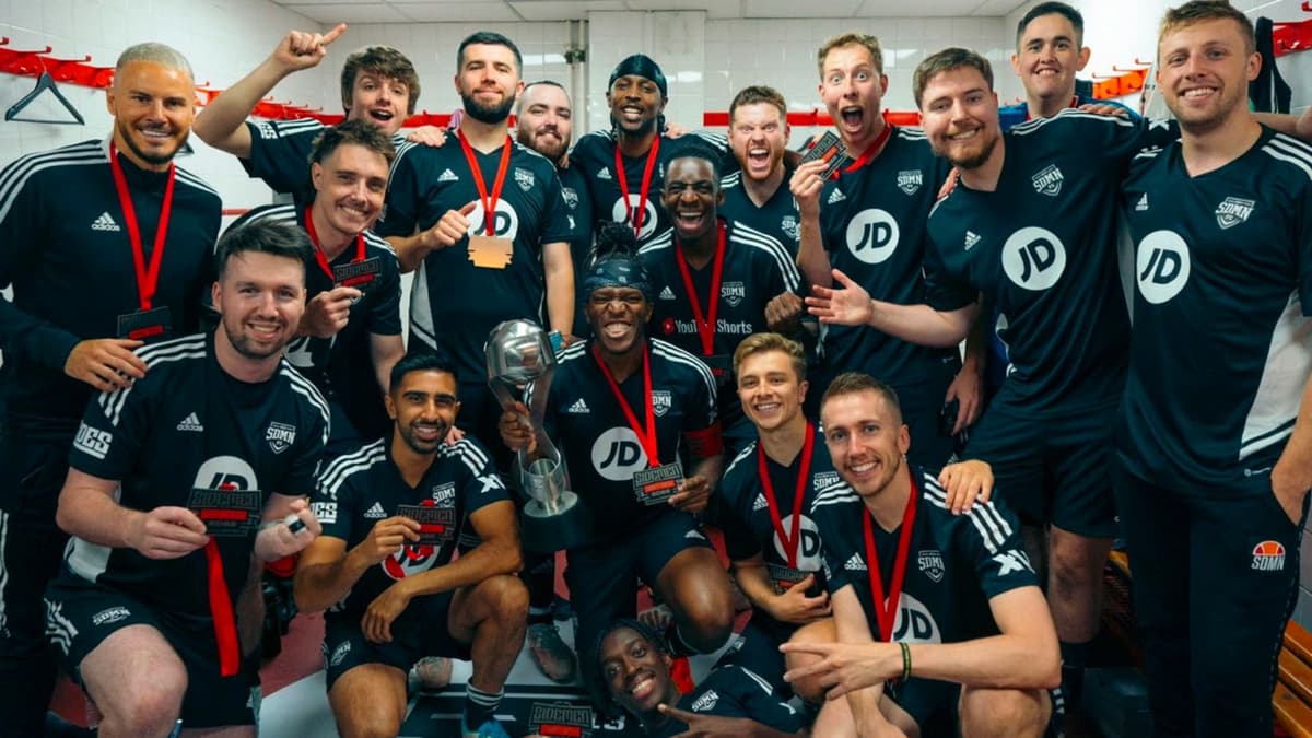 Sidemen FC team in changing room with trophy after match