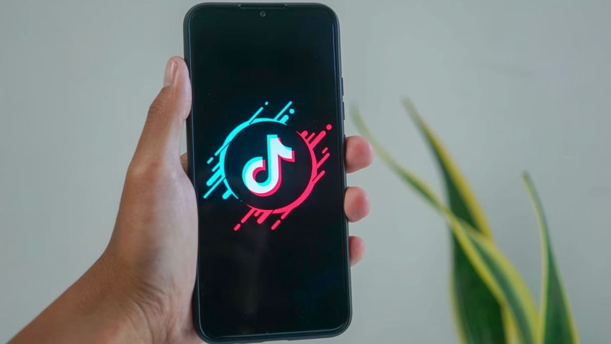 Phone with TikTok logo on screen being held upwards