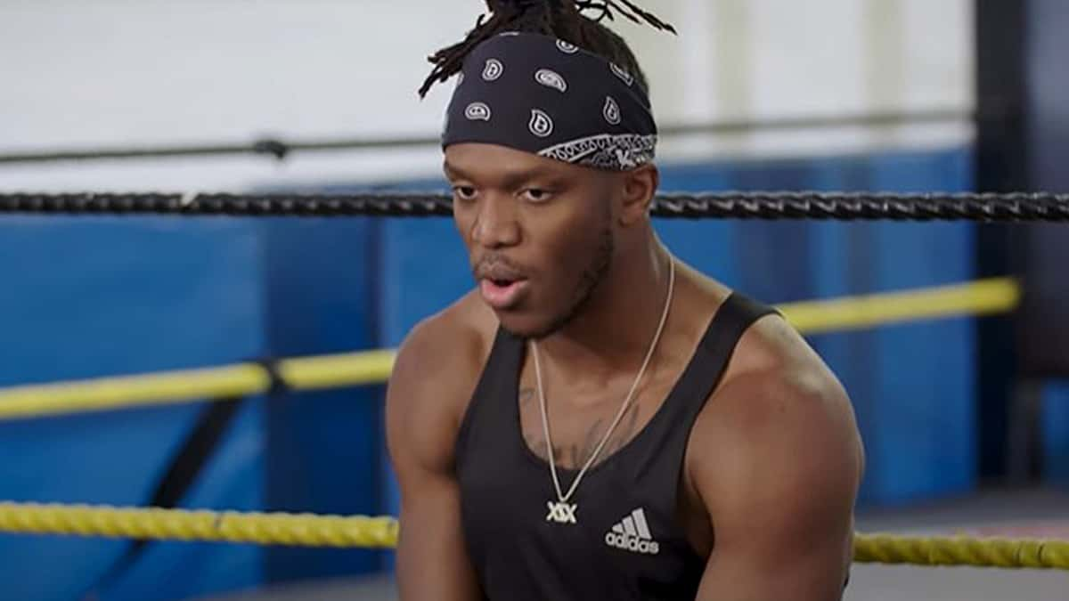 KSI sat on boxing ring in black tanktop