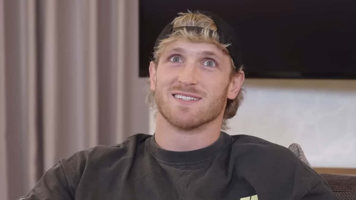 Logan Paul in black t-shirt smiling at camera