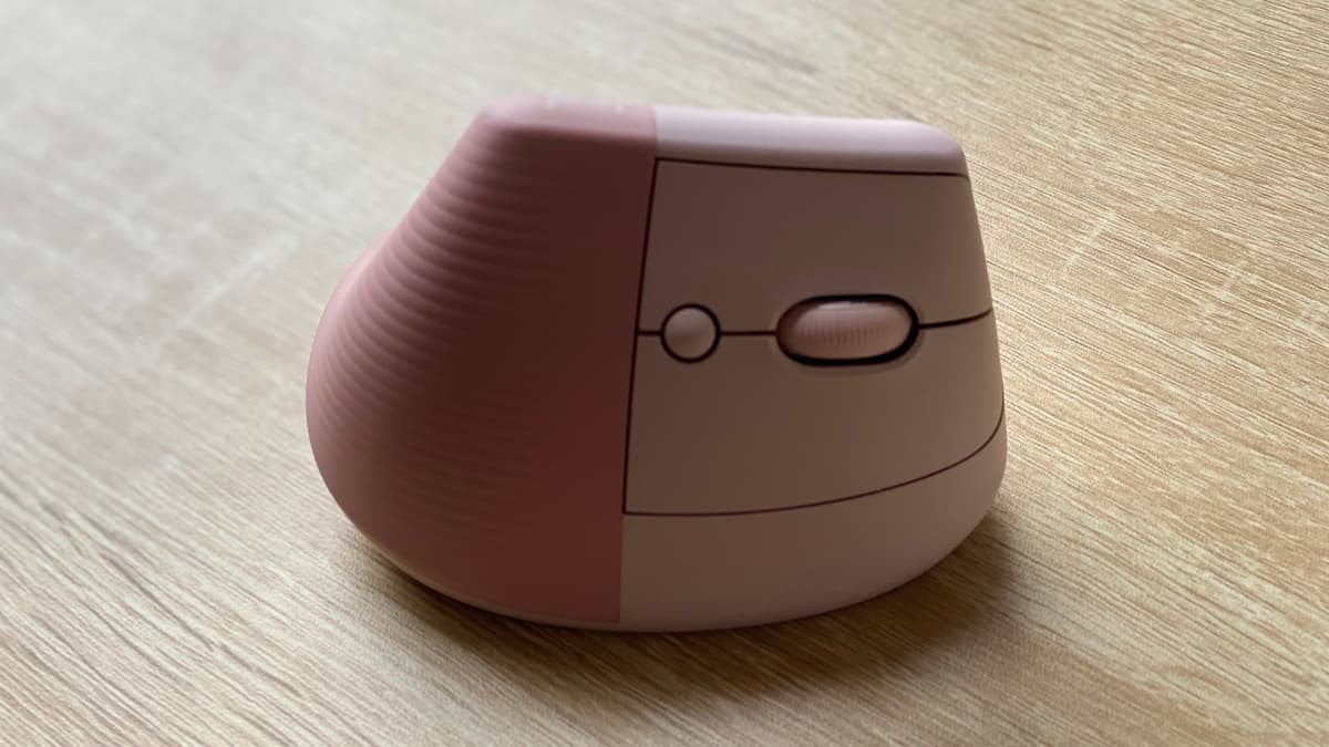 Logitech Lift Vertical Ergonomic Mouse in Rose sitting on a desk