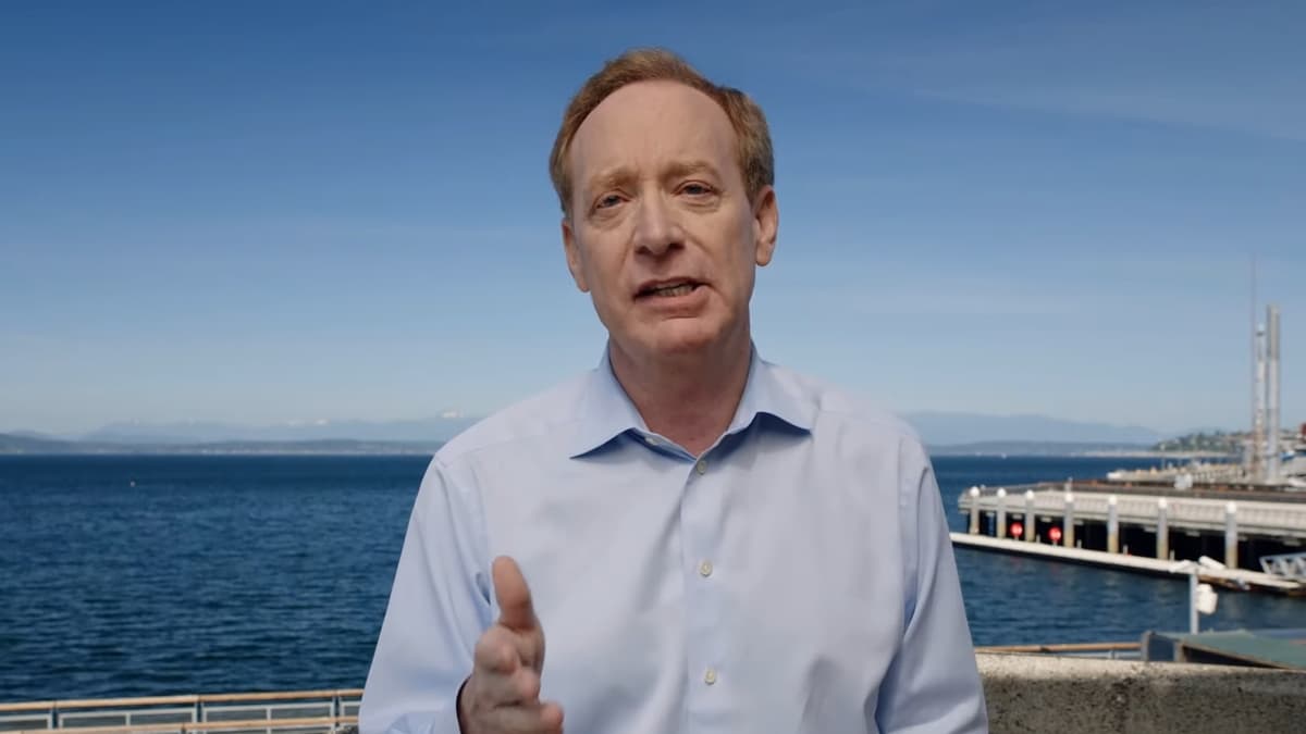 microsoft president brad smith addressing audience on coastline.