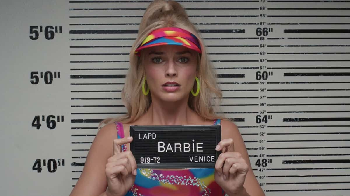 Barbie poses for her mugshot in the Barbie movie