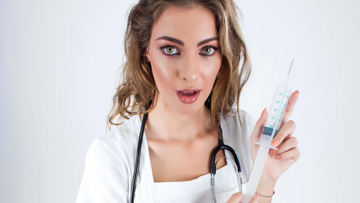 nurse holding needle