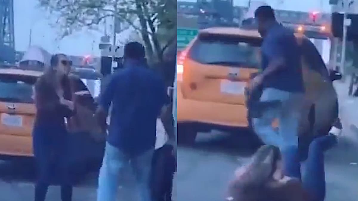 Woman and taxi driver arguing in the middle of a street.