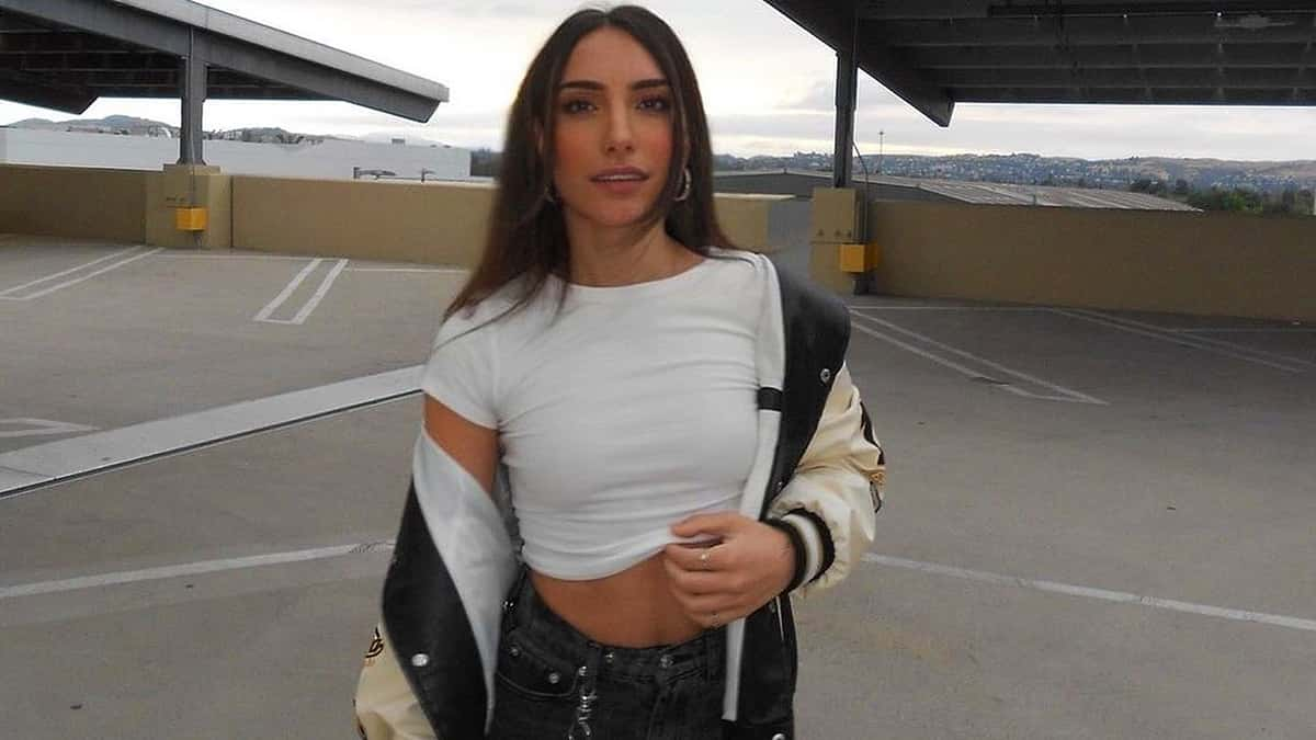 Warzone streamer Nadia Amine taking a photo in a parking lot