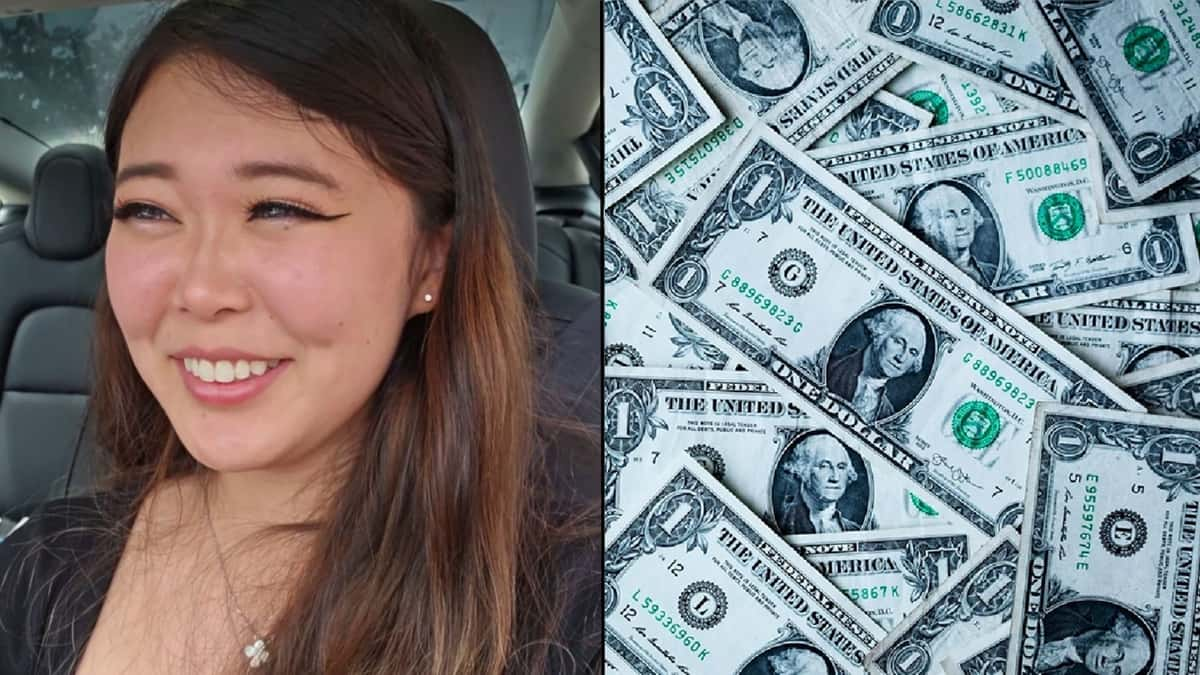 ExtraEmily alongside dollar bills spread on floor