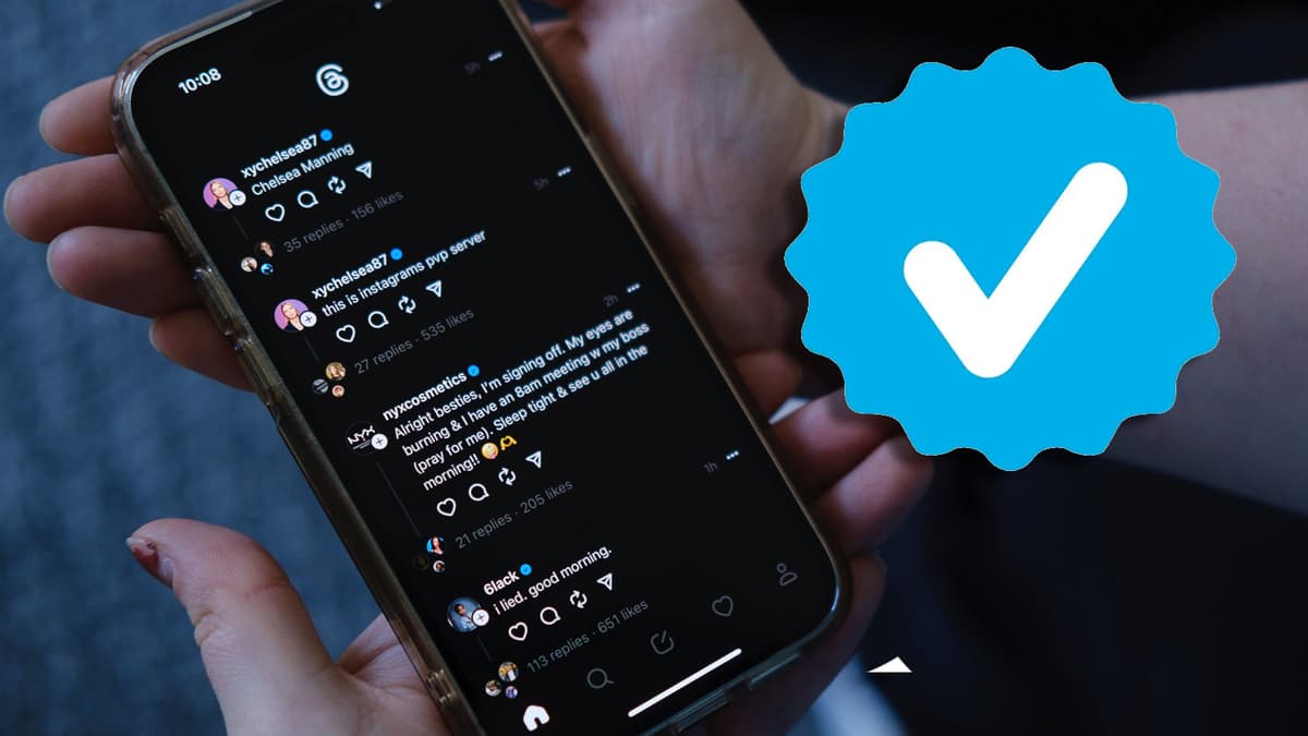 Hand holding phone with Threads app and verified logo on the right hand side.