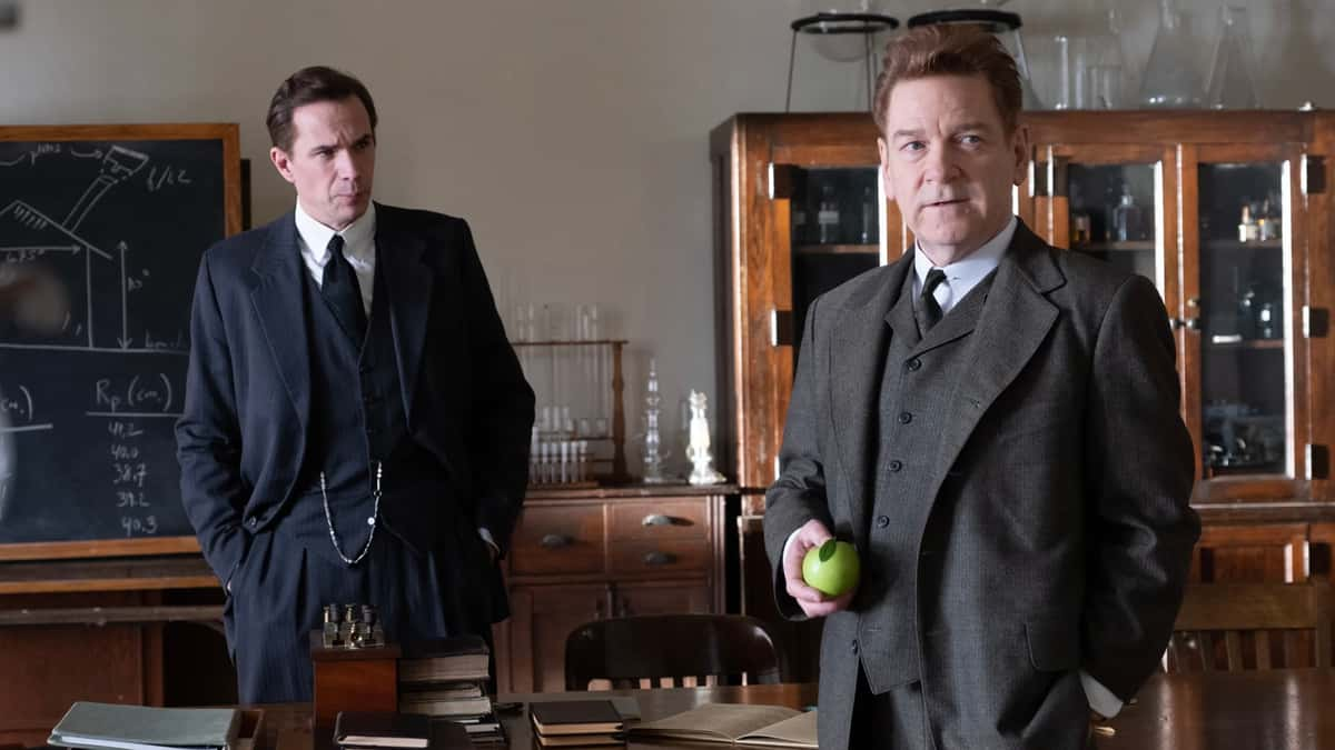 Kenneth Branagh holding an apple in Oppenheimer.