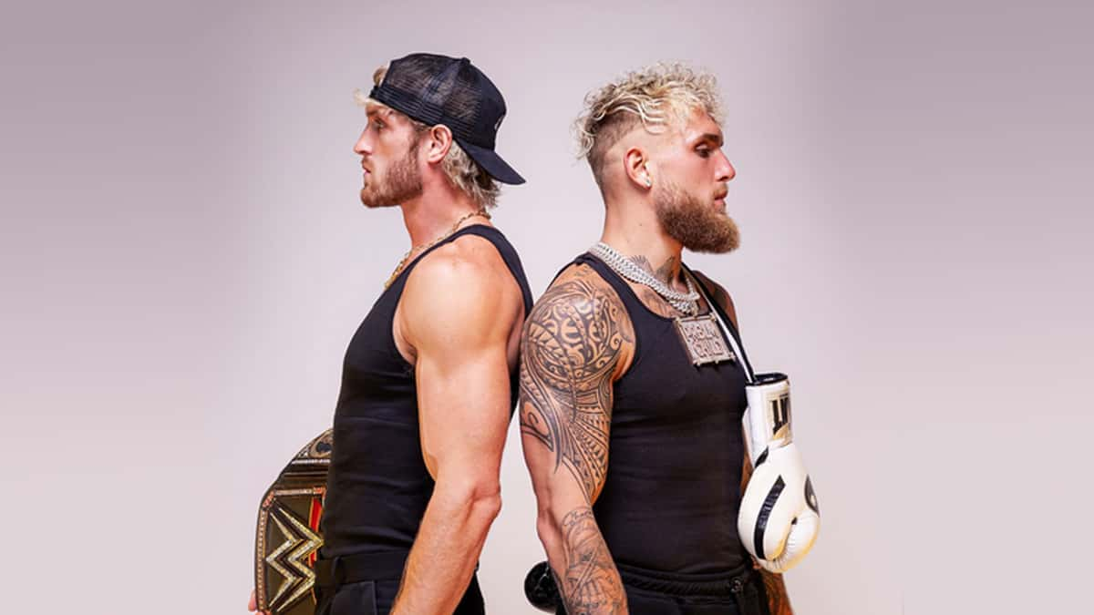 Logan Paul holding WWE belt back to back with Jake Paul holding boxing gloves