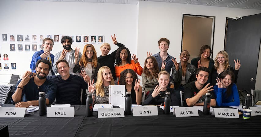 The cast of Ginny and Georgia Season 3 at the first table read, holding up three fingers.