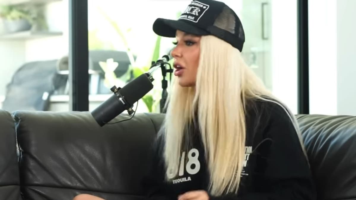 Tana Mongeau wearing a black sweatshirt and hat