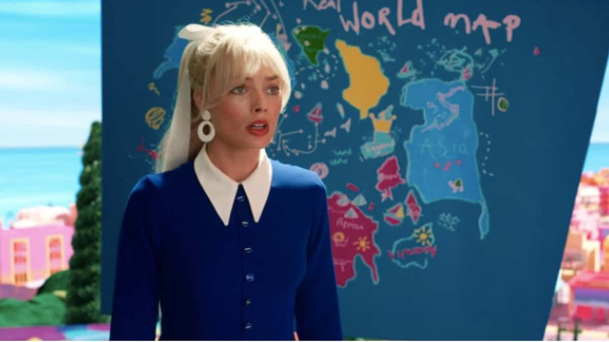 Barbie stands in front of a world map