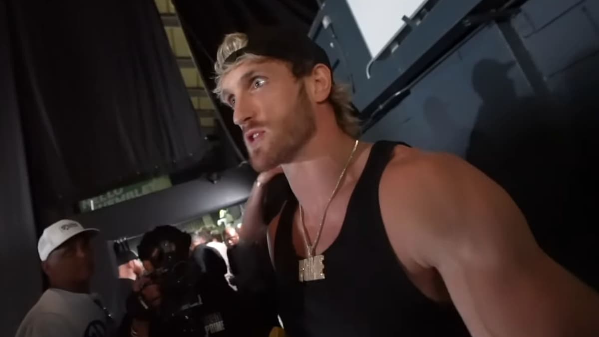 Logan Paul in black tank top backstage at PRIME press conference arguing