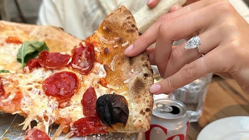 Brooke Sansone shows off her beautiful engagement ring while dining with her fiancee Charlie Puth.