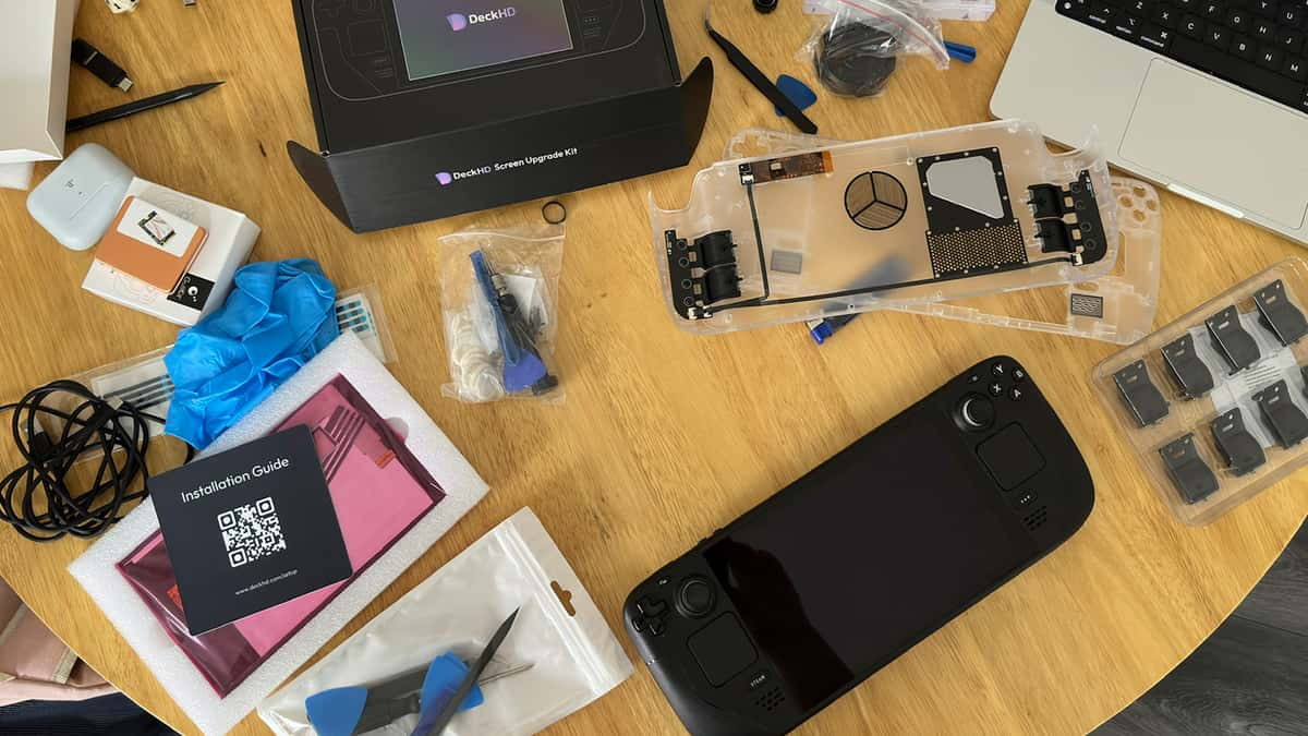 Steam Deck on a table with all equipment surrounding it in a mess