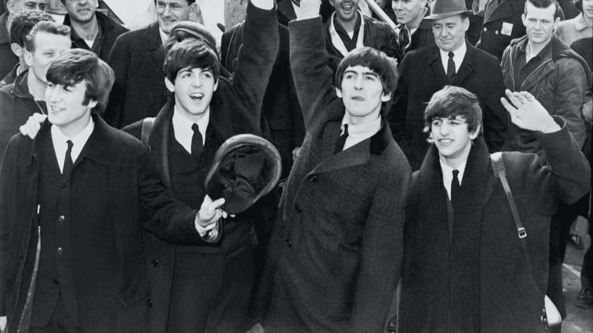 The Beatles waving as they arrive at the JFK Airport.