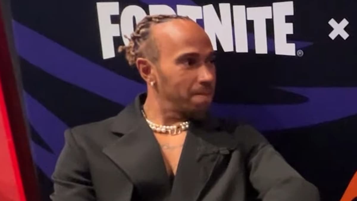 Leiws Hamilton sat in front of Fortnite board