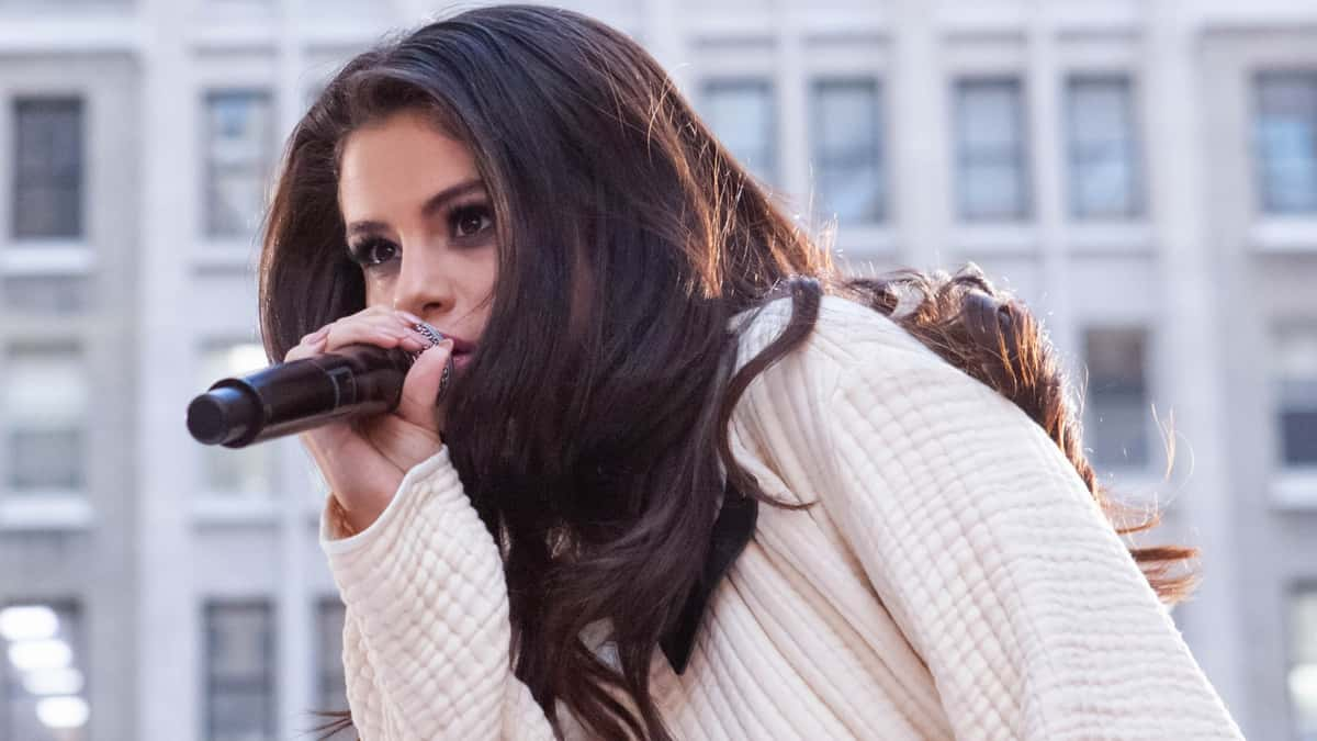 Selena Gomez singing into a microphone