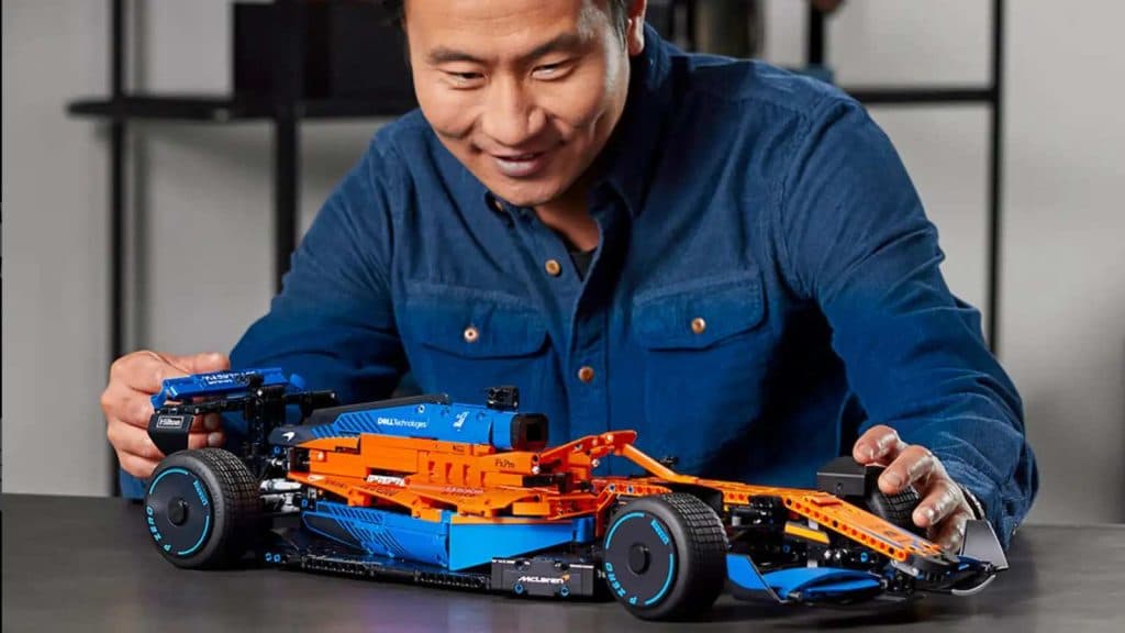 Adult admiring their LEGO Technic McLaren F1 race car. 